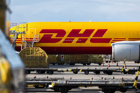 Schkeuditz, Germany - 23th August, 2025 - Many big cargo planes parked on Leipzig Halle airport terminal tarmac apron for loading, service maintenance. DHL air mail express fast logistic hub terminal