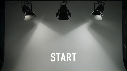 Bright spotlights illuminate an empty studio stage, signaling a new beginning and readiness for a show or presentation to commence
