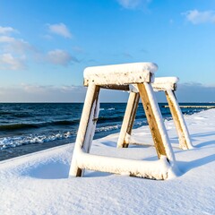 Snowy beach scene with wooden structures