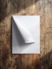 Old blank paper with a curled corner on a wooden background for a business communication template