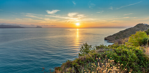 Scenic sunrise view of Altea, Spain, from the coastal path to Albir lighthouse. Golden light over the Mediterranean Sea and picturesque seaside town.