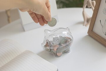 A see through piggy bank with money coins