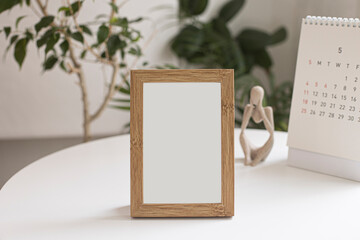 picture frame mock up on white table.