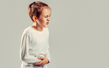 Stomach pain. Teen boy with stomachache. Child having terrible pain in stomach