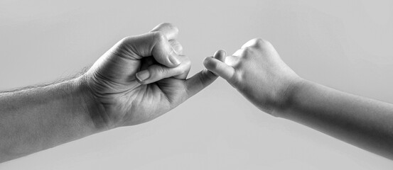 Hand making promise friendship concept. Child hook little finger together. Black and white