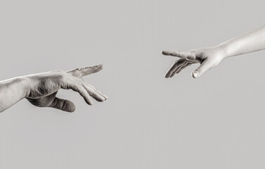 Man and children hands reach toward each other. Child and father hands isolated on gray. Black and white