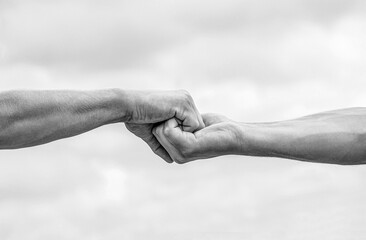 Teamwork, friendship. Rescue, helping gesture or hands. Two hands, helping arm of a friend, teamwork. Black and white