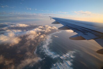 Airplane window view of coastal clouds and waves