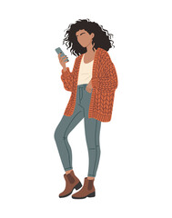 Vector flat illustration of a stylish woman with curly hair wearing jeans, boots, and an orange cardigan, holding a smartphone. Modern casual lifestyle design isolated on transparent background