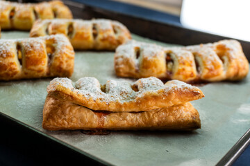 Puff pastry with plum and cinnamon filling. Baked goods. Dessert. Food concept.