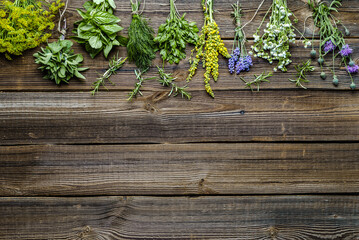Assorted garden fresh herbs on wooden background