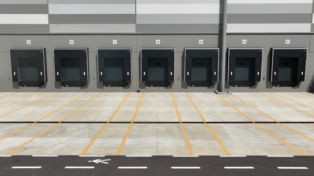 Truck dock platform logistics warehouse empty space door for loading and unloading goods.