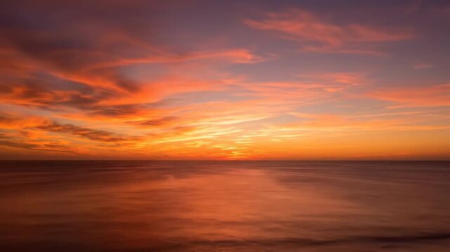 Golden hour sunset colors paint the sky as fast-moving clouds sweep over a vast, tranquil ocean timelapse vast, holiday, colorful