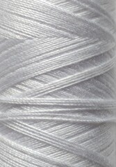 close up of a string white colour delicate color thread yarn plain background manufacturing industry factory hobby work