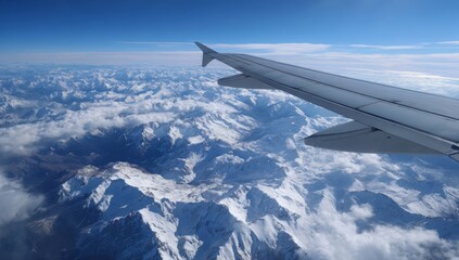 Aerial view of snow-capped mountains from airplane window