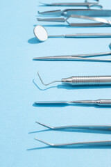 Detailed macro shot showing stainless steel dental instruments on a pure white background.