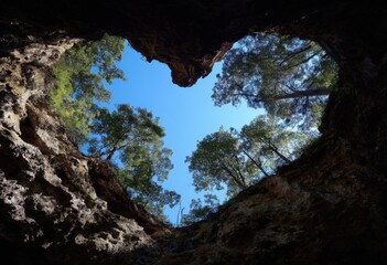 Heart-shaped cave opening to a vibrant sky (1)