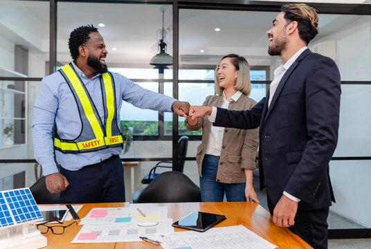 group of multiracial colleagues joining hands in morning meeting motivate team building at office, teamwork of diverse worker business man project engineer standing desk modern workplace - Powered by Adobe