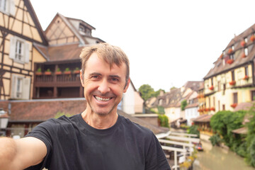Fototapeta premium Family vacation in Colmar, Italy with a beautiful city backdrop and a joyful moment captured