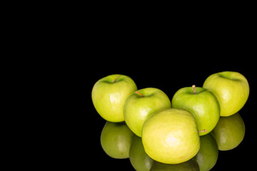 Juicy green apples isolated on black background, close-up.