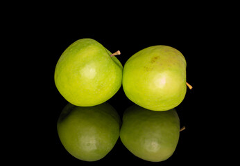 Juicy green apples isolated on black background, close-up.