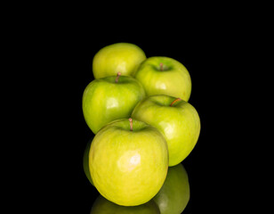 Juicy green apples isolated on black background, close-up.
