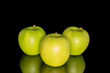 Juicy green apples isolated on black background, close-up.