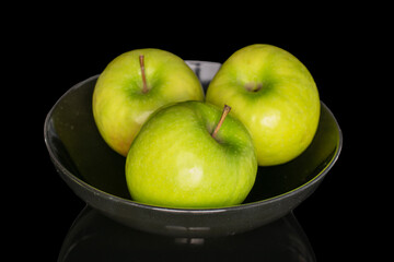 Juicy green apples isolated on black background, close-up.