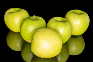 Juicy green apples isolated on black background, close-up.