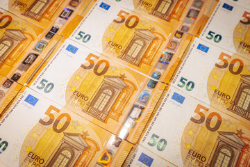 Close-up of multiple 50 euro banknotes spread out in rows, symbolizing wealth, finance, savings,...