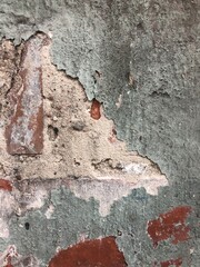 textured gray concrete stone wall with cracks, peeling paint urban background wallpaper texture