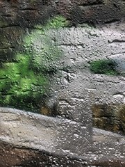 Shiny metallic silver green paint graffiti rough texture wallpaper background close-up