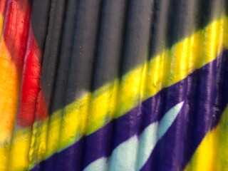 Textured 3d wall red, yellow, purple, black  street-art graffiti paint wallpaper background web texture