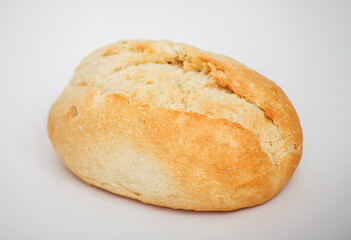 Freshly baked bread roll on a white surface