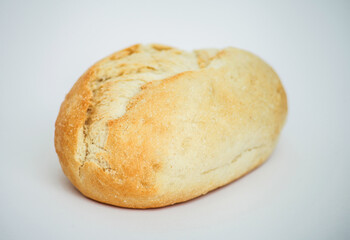 Freshly baked bread roll on a plain white background