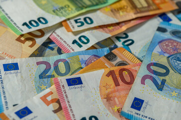 Closeup of Euro bills fanned on table surface