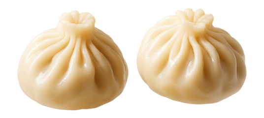 Steamed dumplings with glossy surface and pleated edge on a white background.