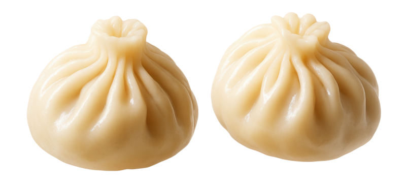 Steamed dumplings with glossy surface and pleated edge on a white background.