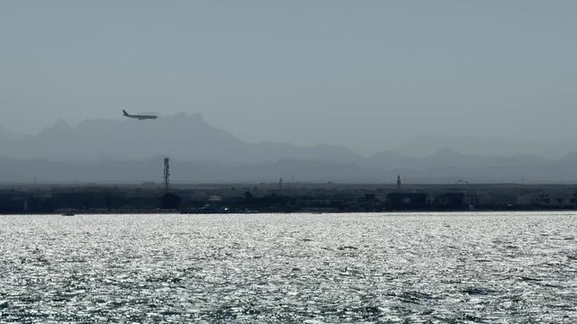 The airplane flying over the sea