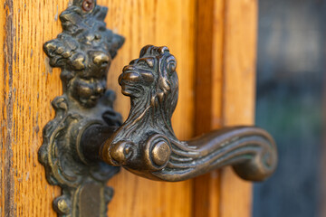 Antique Bronze Door Handle on Old Wooden Door