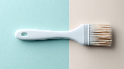 Artisan pastry brush on two-tone backdrop kitchen styling culinary equipment minimalist aesthetic top-down view baking essentials