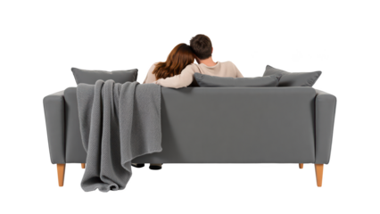 Cozy couple relaxing on modern sofa with blanket, enjoying moment together in comfortable setting