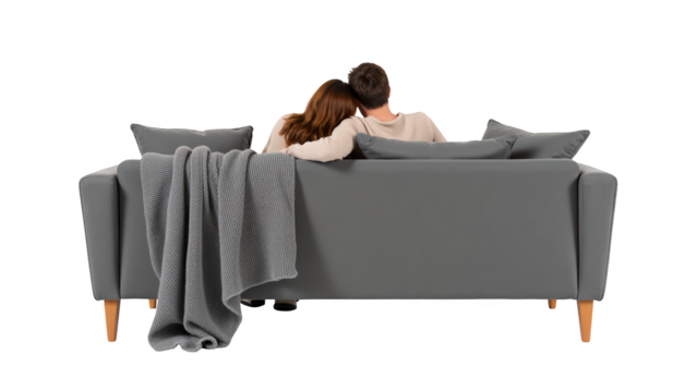 Cozy couple relaxing on modern sofa with blanket, enjoying moment together in comfortable setting