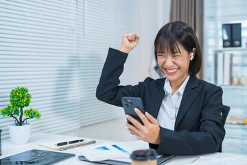 Happy and excited young Asian woman after discussing successful project at work and working concept at office.