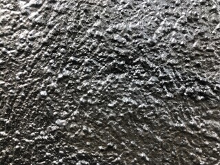 Shiny metallic silver paint graffiti rough texture wallpaper background close-up