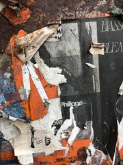 Colorful peeling posters distressed paper texture graffiti detail urban decay wallpaper background © LilliM