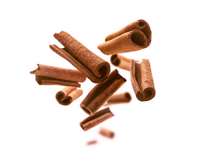 Cinnamon sticks levitate on a white background