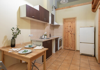 Modern Kitchen Interior with Wooden Cabinets and Dining Table Providing Functionality