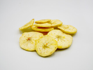 Close-up of natural apple chips with golden texture on white background. Perfect for healthy snack, fruit chips, vegan food, and clean eating lifestyle concepts