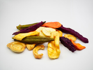 A colorful assortment of natural fruit and vegetable chips on a white background. Perfect for healthy snack, diet, and organic food concepts